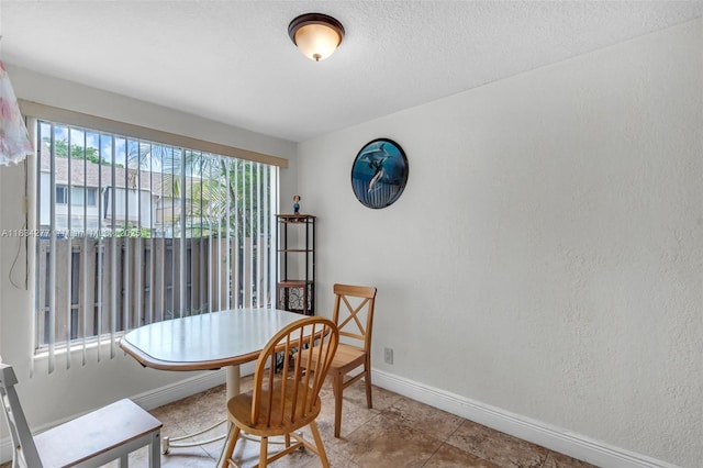 8256 NW 9th Ct Unit 2, Plantation, FL 33324 - dining space with tile patterned floors and a textured ceiling