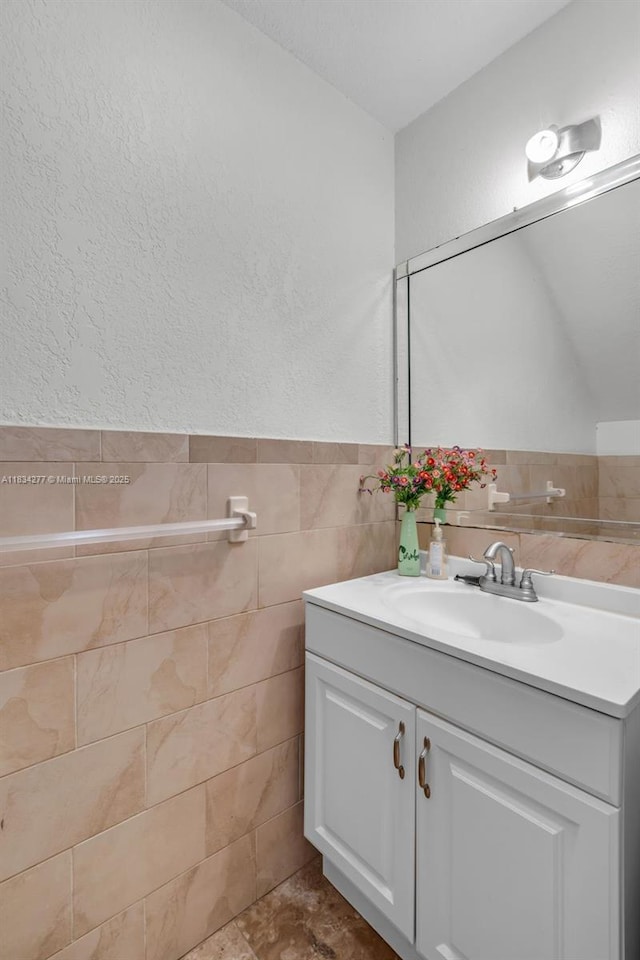 8256 NW 9th Ct Unit 2, Plantation, FL 33324 - bathroom with vanity, a textured wall, and tile walls