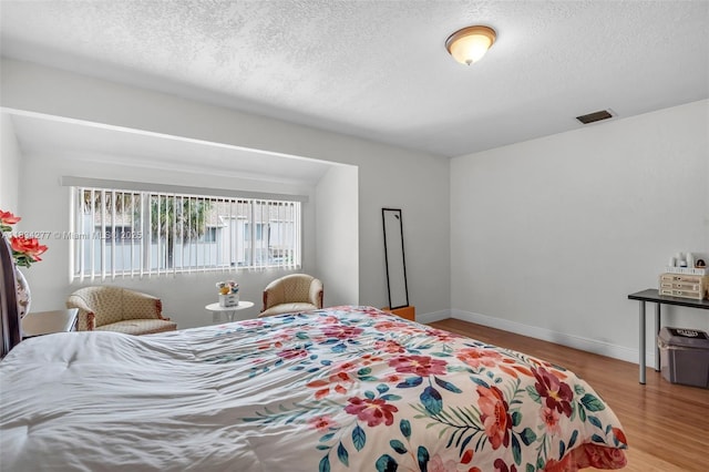 8256 NW 9th Ct Unit 2, Plantation, FL 33324 - bedroom with wood finished floors and a textured ceiling