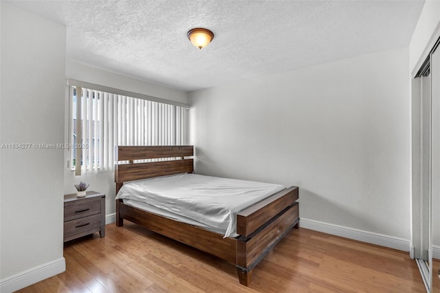 8256 NW 9th Ct Unit 2, Plantation, FL 33324 - bedroom featuring wood finished floors, a textured ceiling, and a closet