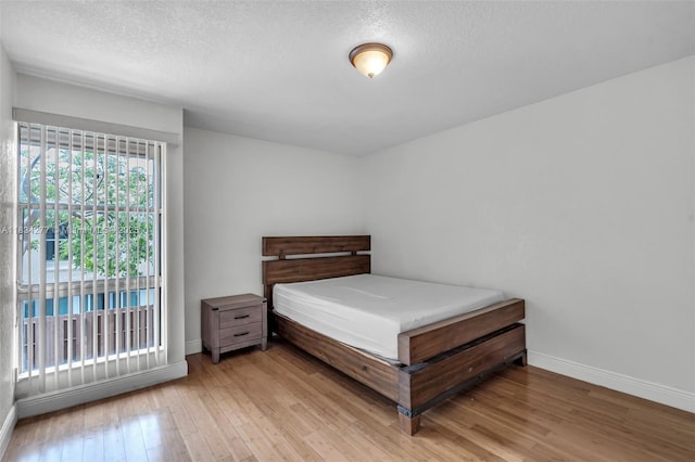 8256 NW 9th Ct Unit 2, Plantation, FL 33324 - bedroom featuring wood finished floors and a textured ceiling