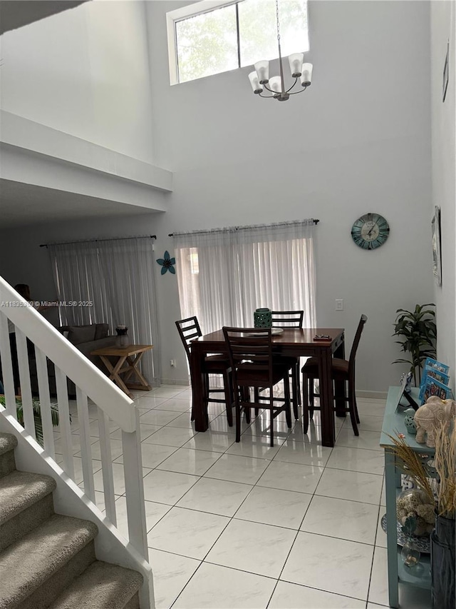 17048 NW 66th Ct, Miami Lakes, FL 33015 - dining space featuring a towering ceiling, a chandelier, stairway, and light tile patterned floors