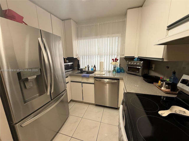 17048 NW 66th Ct, Miami Lakes, FL 33015 - kitchen featuring stainless steel appliances, light tile patterned floors, white cabinetry, and light countertops