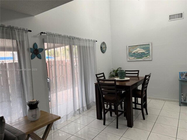 17048 NW 66th Ct, Miami Lakes, FL 33015 - dining room featuring a high ceiling and baseboards