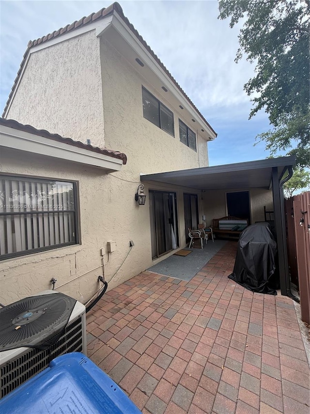 17048 NW 66th Ct, Miami Lakes, FL 33015 - back of house featuring stucco siding and a patio area