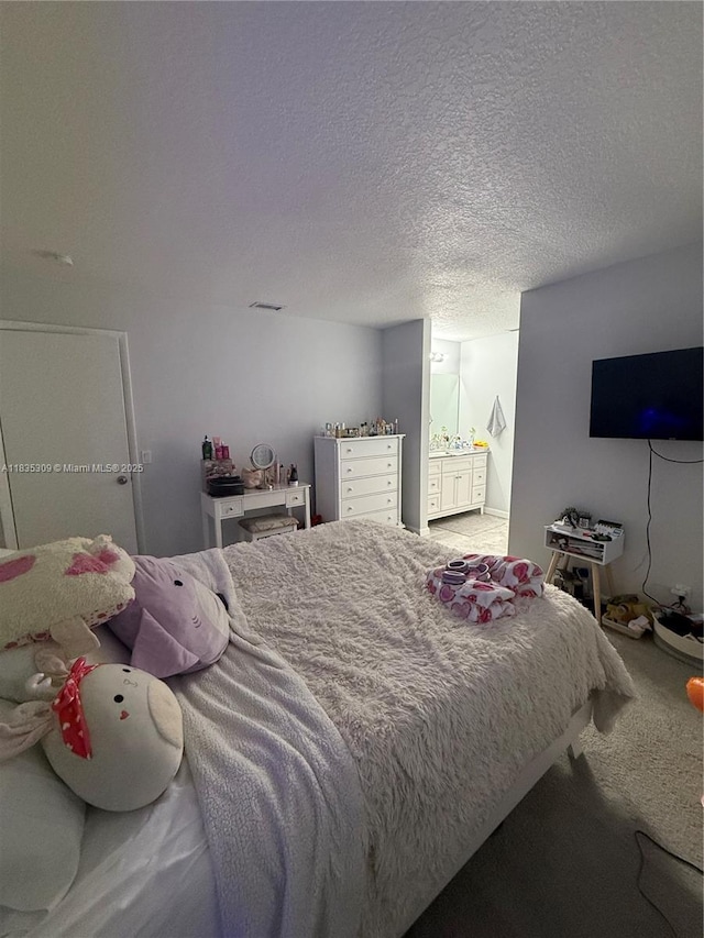 17048 NW 66th Ct, Miami Lakes, FL 33015 - carpeted bedroom featuring ensuite bathroom and a textured ceiling
