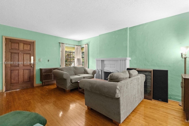 2025 SW 19th St, Miami, FL 33145 - living area with light wood-style flooring, a textured ceiling, and a fireplace