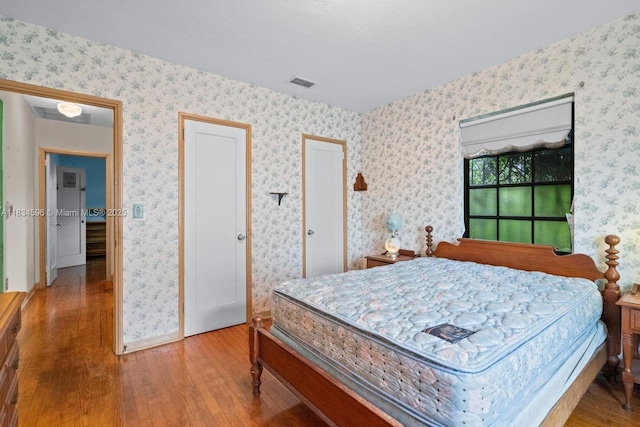 2025 SW 19th St, Miami, FL 33145 - bedroom with wood finished floors and wallpapered walls