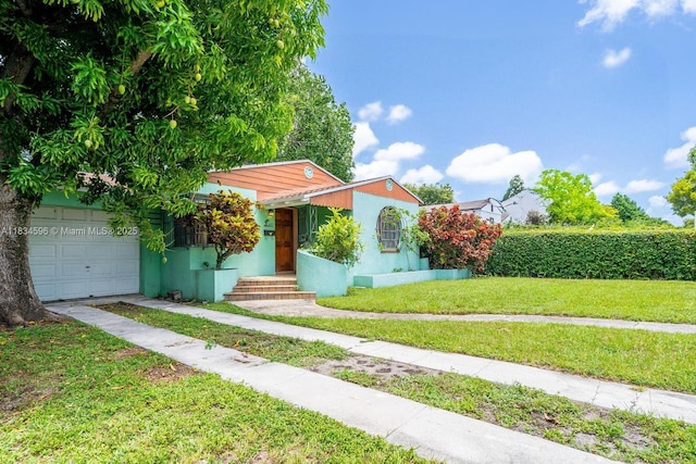 2025 SW 19th St, Miami, FL 33145 - mediterranean / spanish-style home featuring a front yard, a garage, and stucco siding