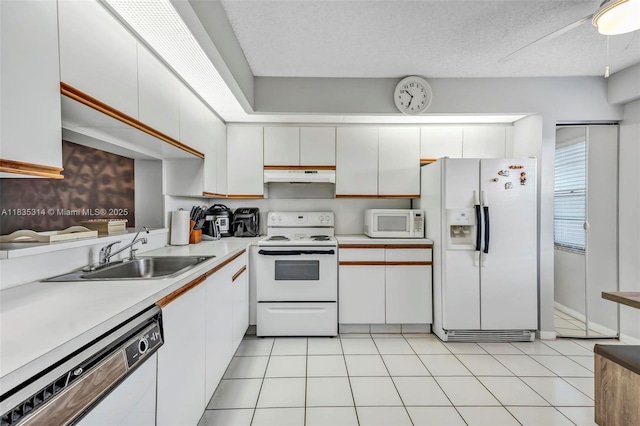 1300 SW 125th Ave Unit 406K, Pembroke Pines, FL 33027 - kitchen featuring white appliances, under cabinet range hood, white cabinetry, light countertops, and a textured ceiling