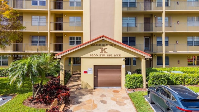1300 SW 125th Ave Unit 406K, Pembroke Pines, FL 33027 - view of apartment building / complex with a garage
