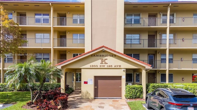 1300 SW 125th Ave Unit 406K, Pembroke Pines, FL 33027 - view of apartment building / complex with a garage