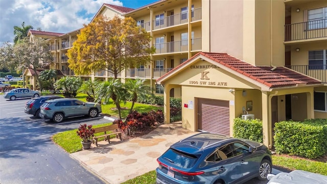 1300 SW 125th Ave Unit 406K, Pembroke Pines, FL 33027 - view of building exterior featuring uncovered parking