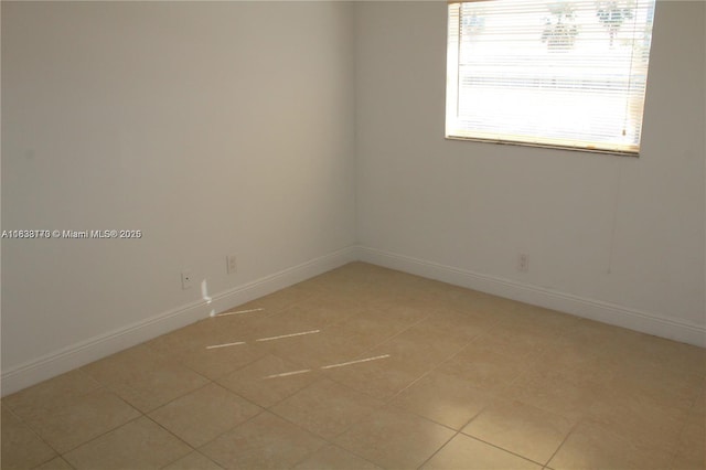 101 NE 41st St Unit F107, Oakland Park, FL 33334 - spare room with baseboards and light tile patterned flooring