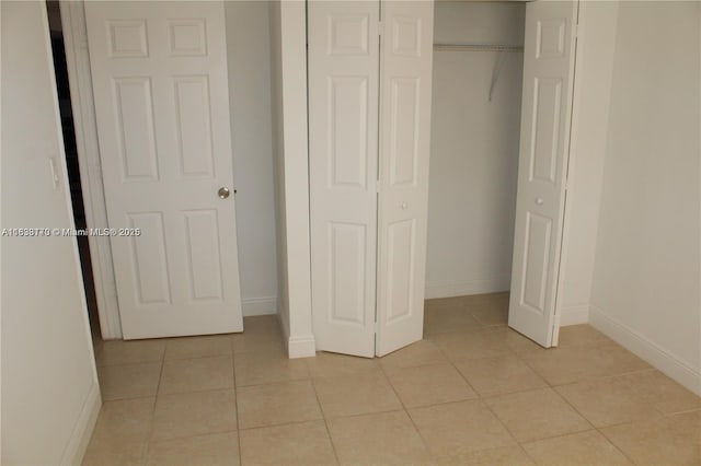 101 NE 41st St Unit F107, Oakland Park, FL 33334 - unfurnished bedroom featuring a closet and light tile patterned floors