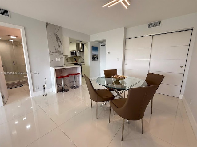 20379 W Country Club Dr Unit 1434, Aventura, FL 33180 - dining area with baseboards and light tile patterned floors