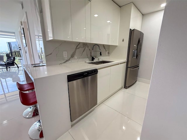 20379 W Country Club Dr Unit 1434, Aventura, FL 33180 - kitchen featuring stainless steel dishwasher, modern cabinets, fridge with ice dispenser, and white cabinets