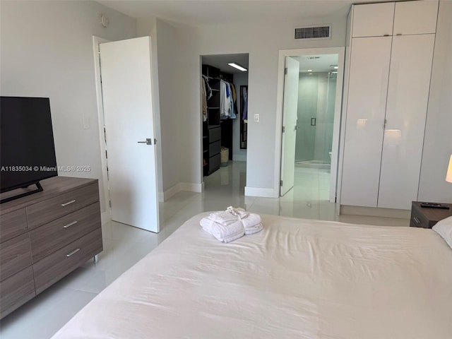 20379 W Country Club Dr Unit 1434, Aventura, FL 33180 - bedroom featuring a walk in closet, a closet, light tile patterned flooring, and ensuite bathroom