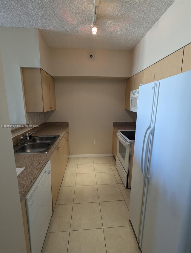 616 Clearwater Park Rd Unit 703, West Palm Beach, FL 33401 - kitchen with white appliances, a textured ceiling, dark countertops, and light tile patterned floors