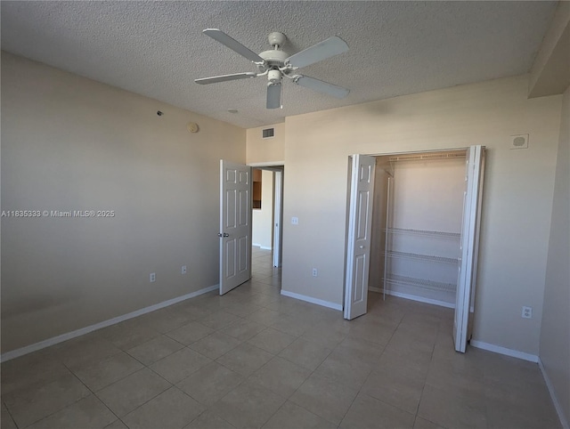 616 Clearwater Park Rd Unit 703, West Palm Beach, FL 33401 - unfurnished bedroom with a closet, a textured ceiling, tile patterned flooring, and ceiling fan