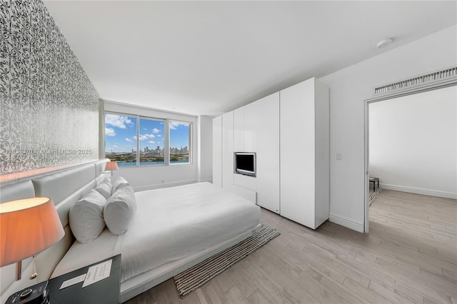 1100 W Ave Unit 1614, Miami Beach, FL 33139 - bedroom with light wood-style floors and baseboards