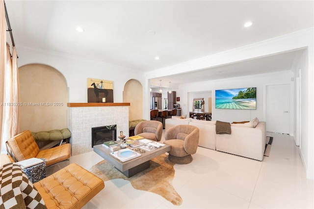 2485 SW 19th Ter, Miami, FL 33145 - living area featuring ornamental molding, tile patterned flooring, a glass covered fireplace, recessed lighting, and arched walkways