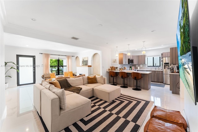 2485 SW 19th Ter, Miami, FL 33145 - living area featuring light tile patterned flooring, arched walkways, and recessed lighting