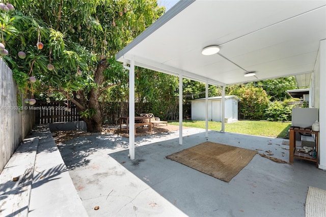 2485 SW 19th Ter, Miami, FL 33145 - fenced backyard with a patio area, a storage unit, and outdoor dining space