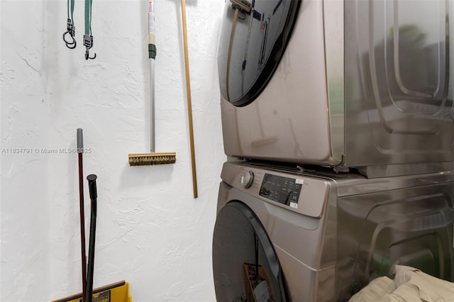 7450 NW 17th St Unit 207, Plantation, FL 33313 - washroom featuring stacked washing machine and dryer and a textured wall