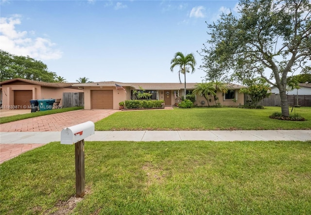 11193 SW 113th Ter, Miami, FL 33176 - ranch-style home with decorative driveway, an attached garage, and stucco siding