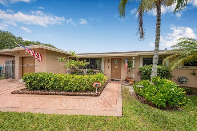 11193 SW 113th Ter, Miami, FL 33176 - view of front facade with stucco siding, a garage, and decorative driveway