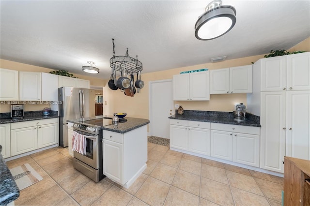 11193 SW 113th Ter, Miami, FL 33176 - kitchen with appliances with stainless steel finishes, white cabinets, light tile patterned flooring, and a kitchen island