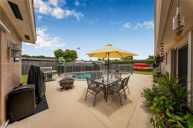11193 SW 113th Ter, Miami, FL 33176 - view of swimming pool featuring a patio, a fenced backyard, a fire pit, area for grilling, and outdoor dining space