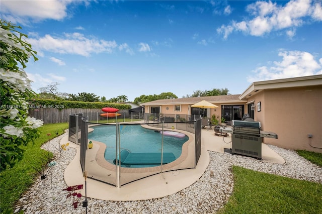 11193 SW 113th Ter, Miami, FL 33176 - view of pool featuring area for grilling, a fenced backyard, and a patio area