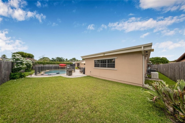 11193 SW 113th Ter, Miami, FL 33176 - back of house with stucco siding, a fenced backyard, and a patio area