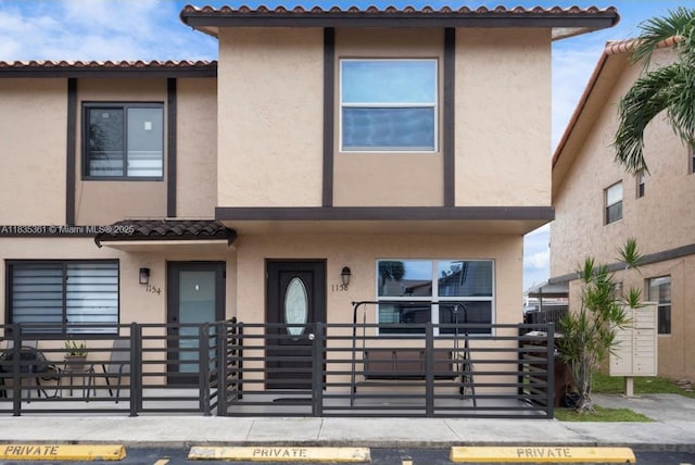 1158 W 41st St Unit 87, Hialeah, FL 33012 - view of property featuring stucco siding and a tiled roof