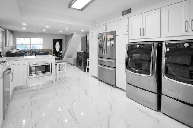1158 W 41st St Unit 87, Hialeah, FL 33012 - kitchen with stainless steel appliances, separate washer and dryer, white cabinetry, recessed lighting, and open floor plan