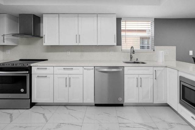 1158 W 41st St Unit 87, Hialeah, FL 33012 - kitchen featuring stainless steel appliances, wall chimney range hood, light marble finish floors, white cabinetry, and light countertops