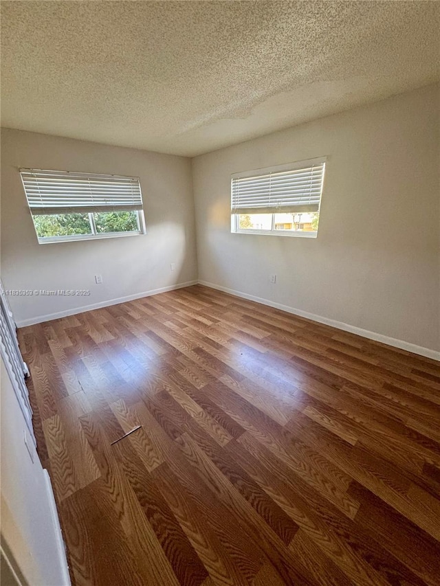 8240 SW 149th Ct Unit 7-202, Miami, FL 33193 - empty room featuring a textured ceiling and wood finished floors