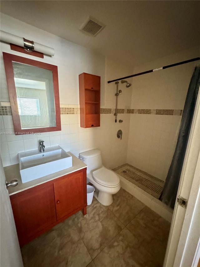 8240 SW 149th Ct Unit 7-202, Miami, FL 33193 - bathroom featuring a shower stall, vanity, tile patterned floors, and tile walls