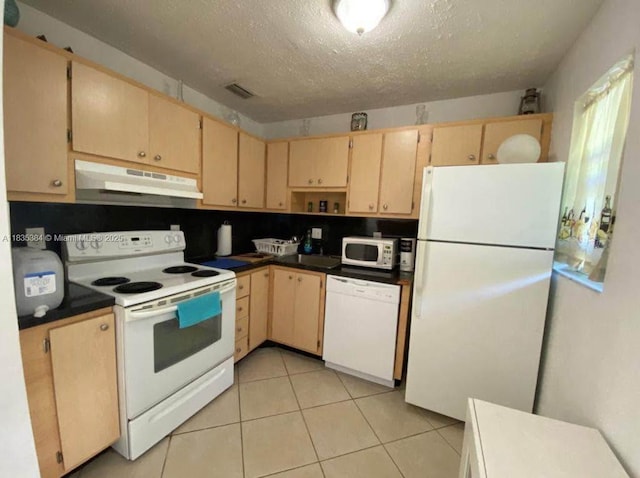 700 Layne Blvd Unit 115, Hallandale Beach, FL 33009 - kitchen featuring white appliances, under cabinet range hood, light brown cabinets, dark countertops, and a textured ceiling