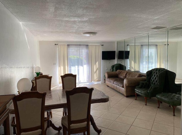 700 Layne Blvd Unit 115, Hallandale Beach, FL 33009 - dining room featuring plenty of natural light, light tile patterned floors, and a textured ceiling