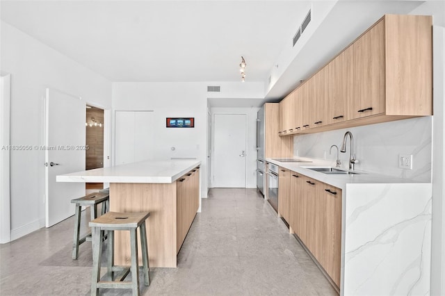 90 SW 3rd St Unit 3810, Miami, FL 33130 - kitchen featuring modern cabinets, a kitchen island, light brown cabinetry, and a breakfast bar area