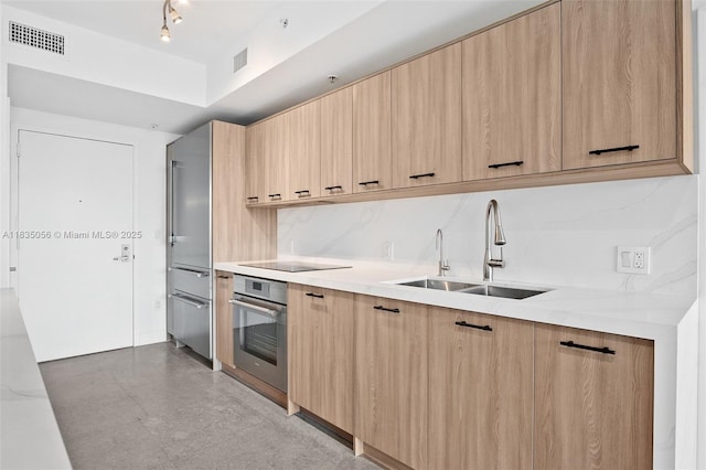 90 SW 3rd St Unit 3810, Miami, FL 33130 - kitchen featuring stainless steel oven, modern cabinets, light brown cabinets, decorative backsplash, and black electric cooktop
