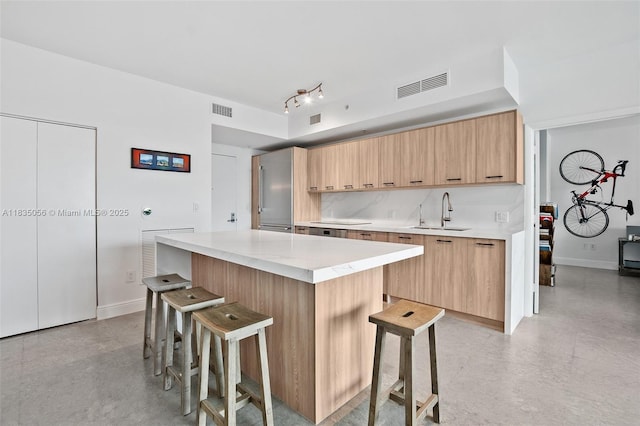90 SW 3rd St Unit 3810, Miami, FL 33130 - kitchen with a breakfast bar, modern cabinets, light countertops, and light brown cabinetry