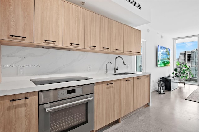 90 SW 3rd St Unit 3810, Miami, FL 33130 - kitchen with oven, light brown cabinetry, and expansive windows