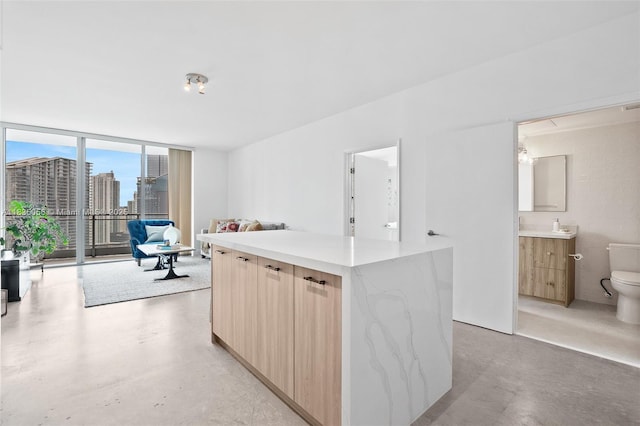 90 SW 3rd St Unit 3810, Miami, FL 33130 - kitchen featuring modern cabinets, concrete flooring, open floor plan, and a wall of windows
