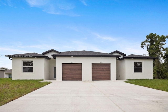 4873/4875 29th St SW, Lehigh Acres, FL 33973 - prairie-style house featuring an attached garage, driveway, stucco siding, and a front yard
