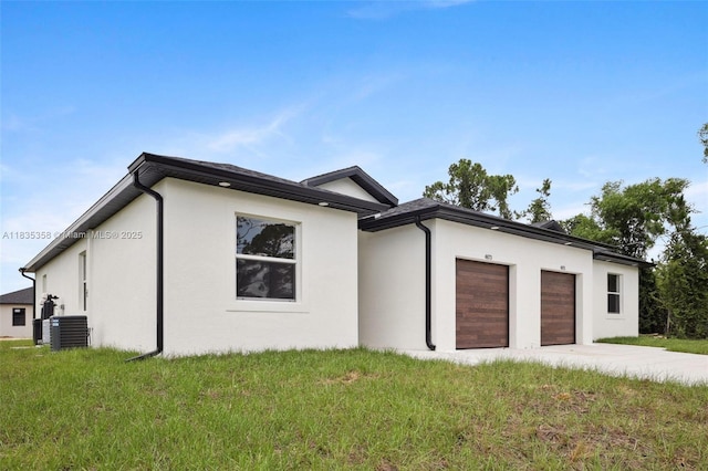 4873/4875 29th St SW, Lehigh Acres, FL 33973 - view of front of home featuring stucco siding, an attached garage, driveway, and a front yard