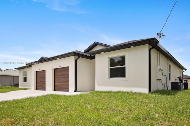 4873/4875 29th St SW, Lehigh Acres, FL 33973 - view of front of property with stucco siding, a garage, concrete driveway, and a front yard